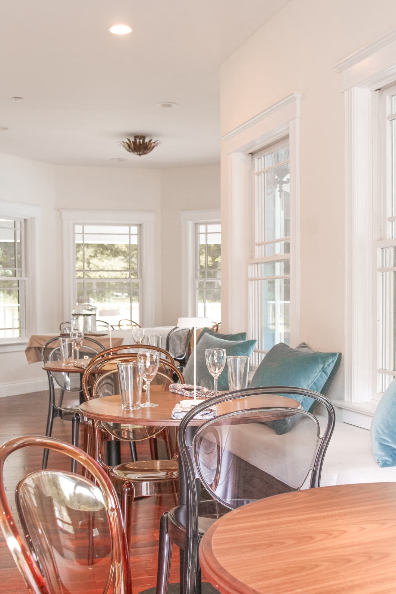 Sunlit farmhouse dining room set for guests
